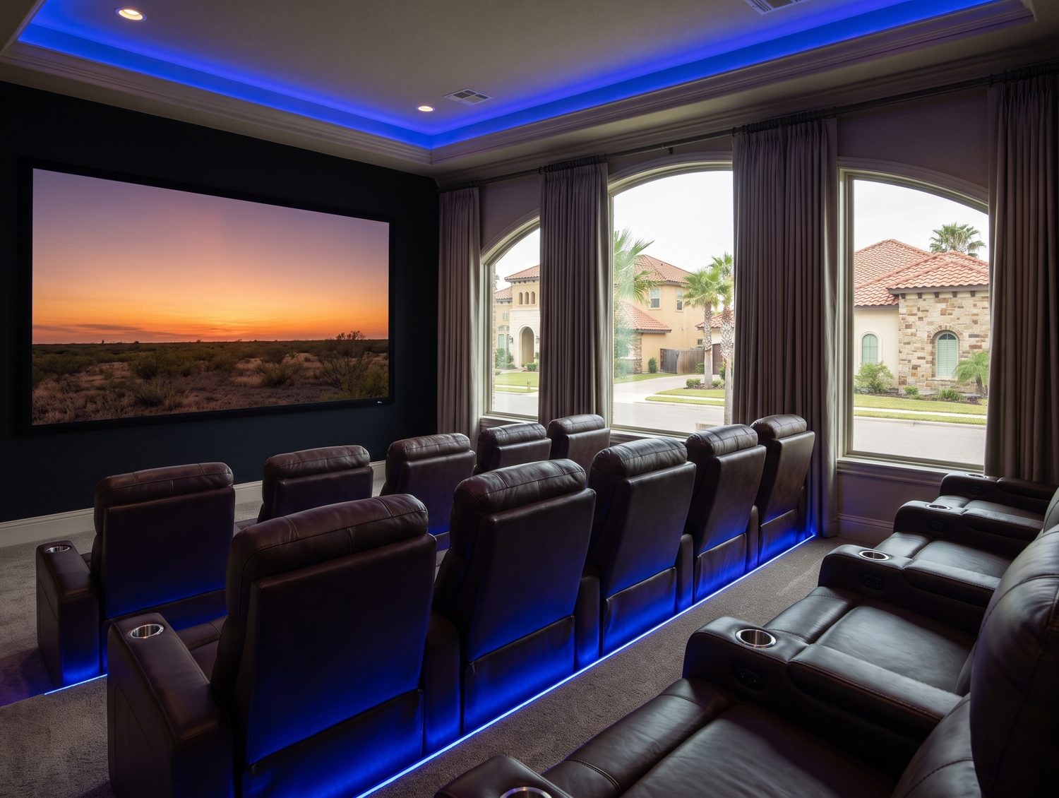 A home theater with rows of recliners and a large screen