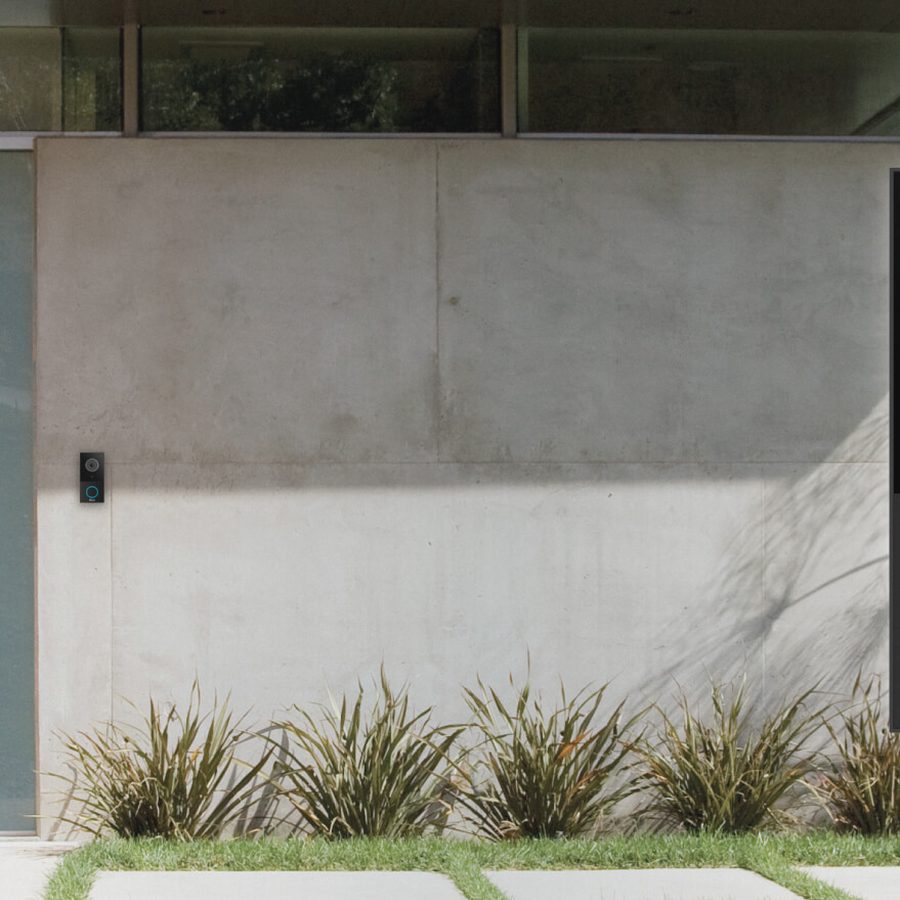 A Nice Video Doorbell mounted beside a front door