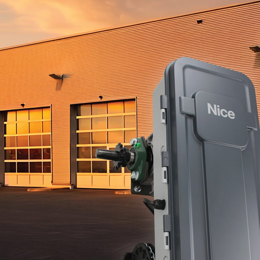 A Nice MCX commercial door operator mounted beside an overhead door