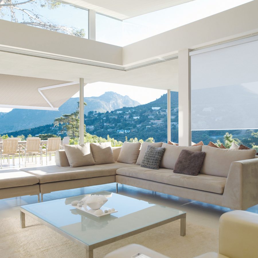 A motorized shade system in a bright, finished room
